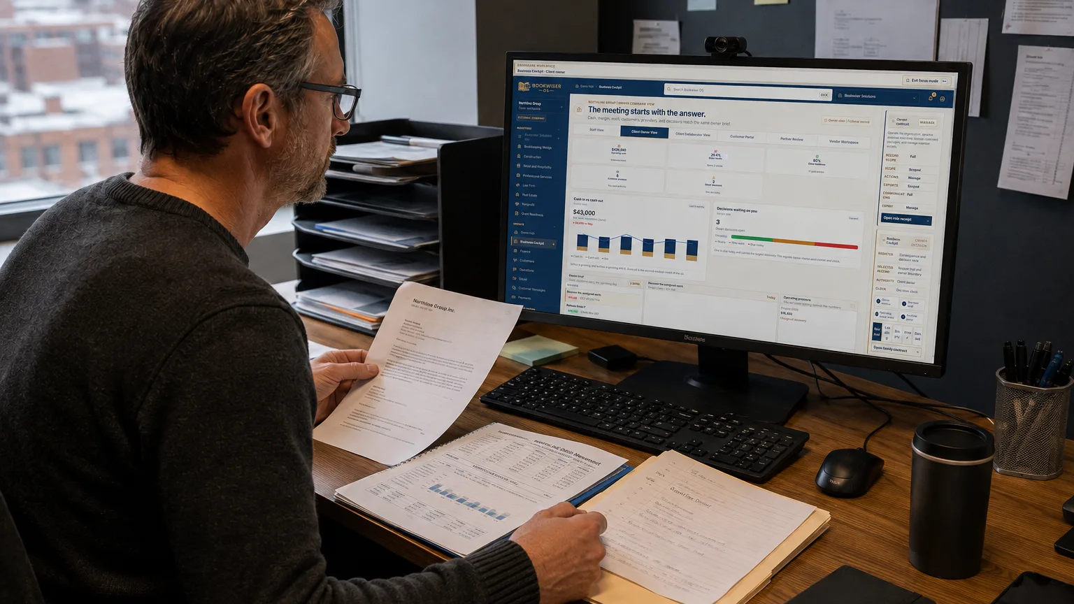 business owner working at a desk with an operating review screen